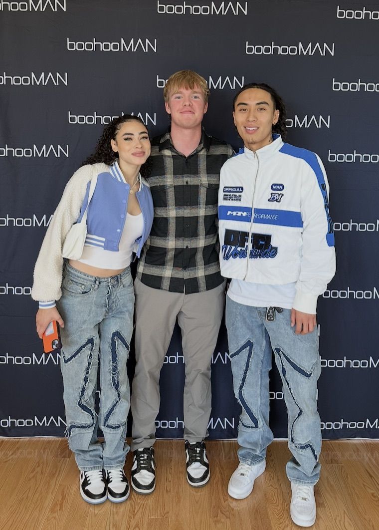 Three RealQuick Media creators at the boohooMAN gifting suite press wall