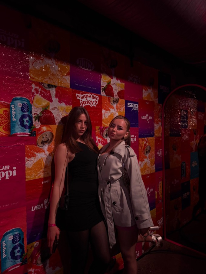 Creators in front of the Poppi 'wanna get juicy' wall at the London launch party