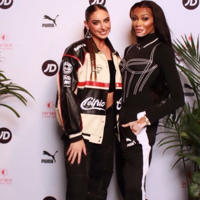 Creator with Winnie Harlow on the Puma x JD step-and-repeat at the NYC launch