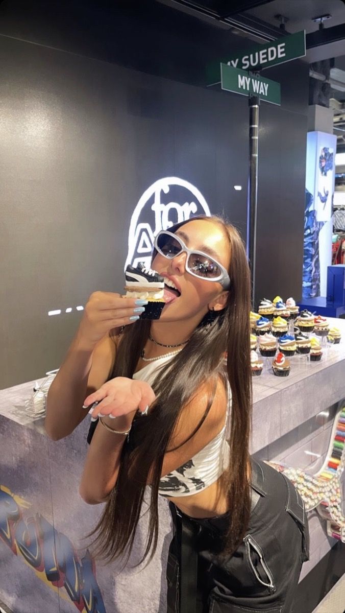 Creator tasting a Puma sneaker cupcake under the 'My Suede My Way' sign at the NYC launch